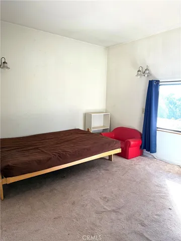 a bedroom with a bed and a table