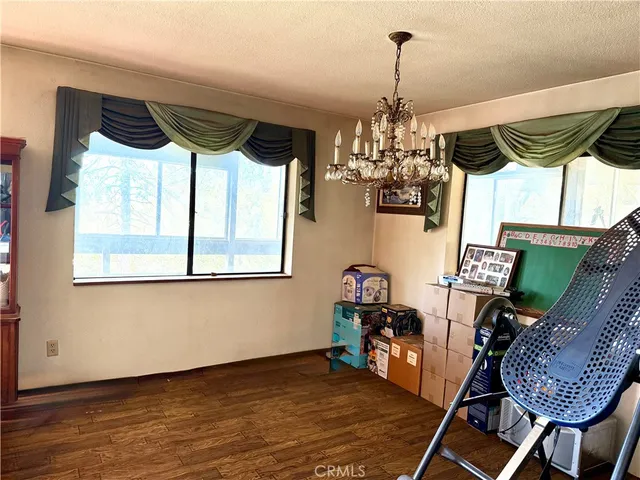a view of a dining room with furniture and chandelier