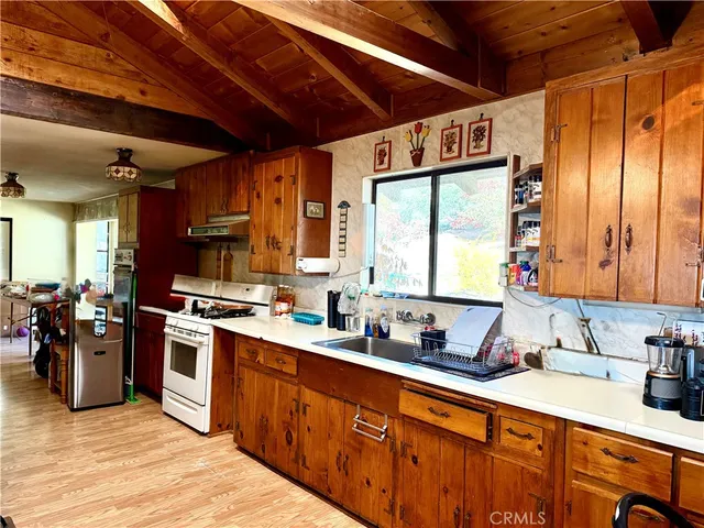 a kitchen with stainless steel appliances granite countertop a sink stove and cabinets