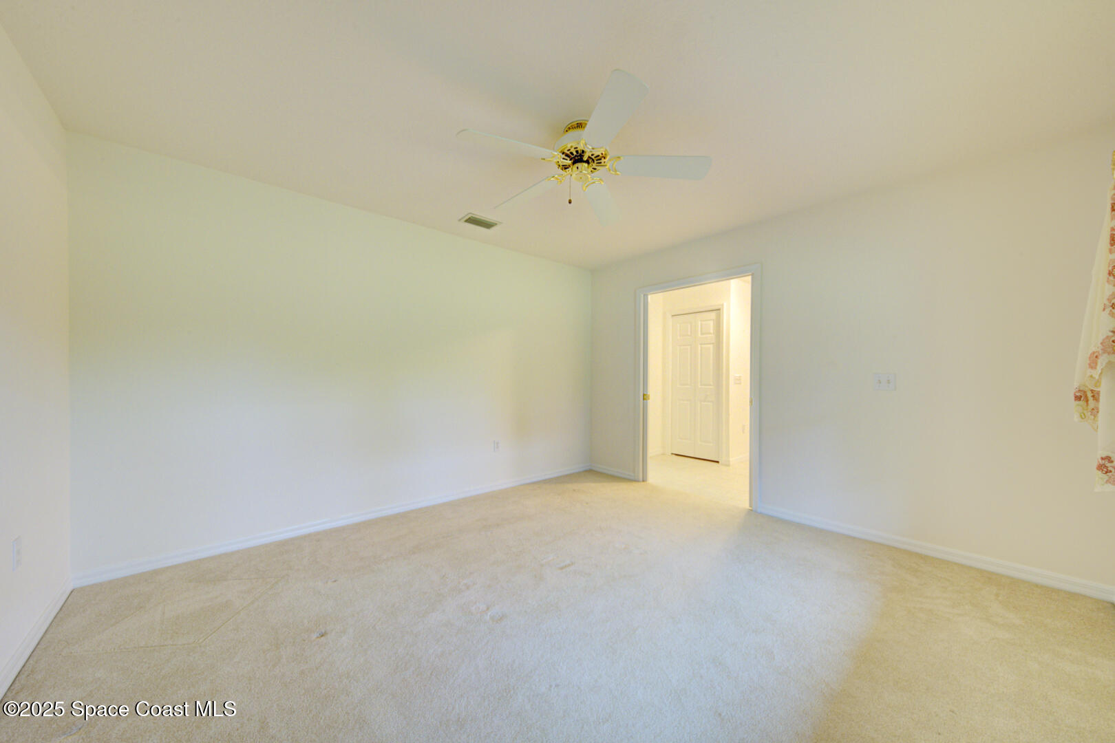 3105 Diamond Road Titusville, FL 32796 - Photo 12 of 81 a view of an empty room with a ceiling fan