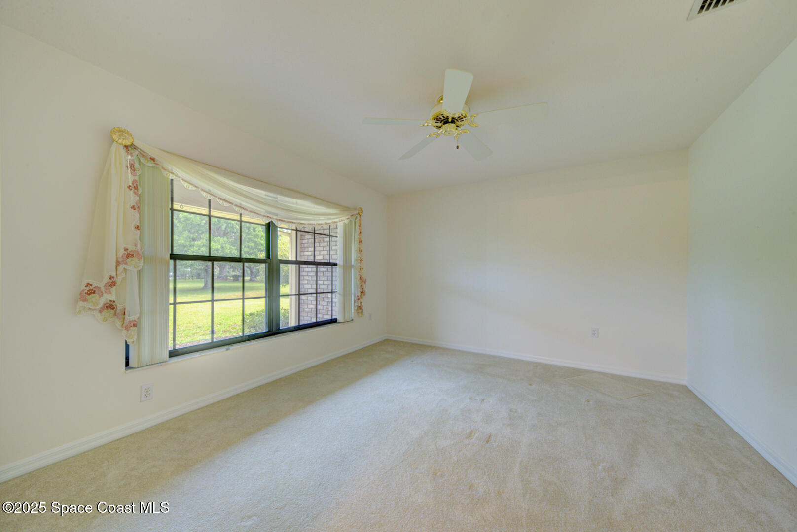 3105 Diamond Road Titusville, FL 32796 - Photo 17 of 81 a view of an empty room with a window