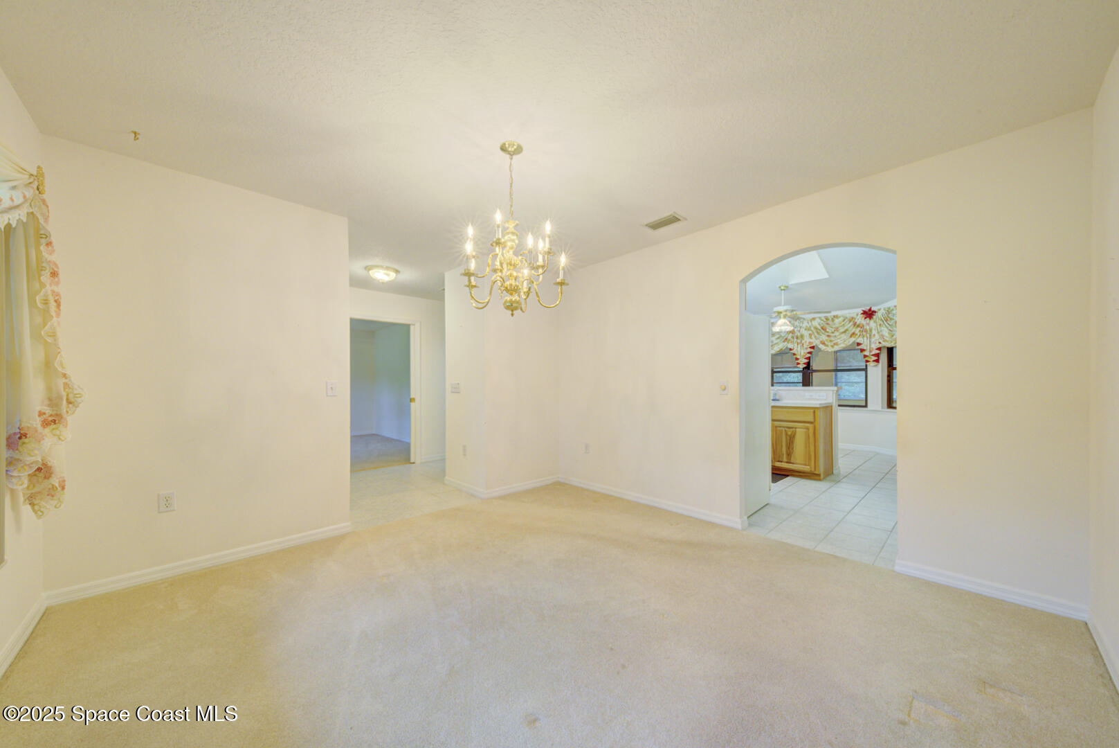 3105 Diamond Road Titusville, FL 32796 - Photo 18 of 81 a view of a chandelier in an empty room