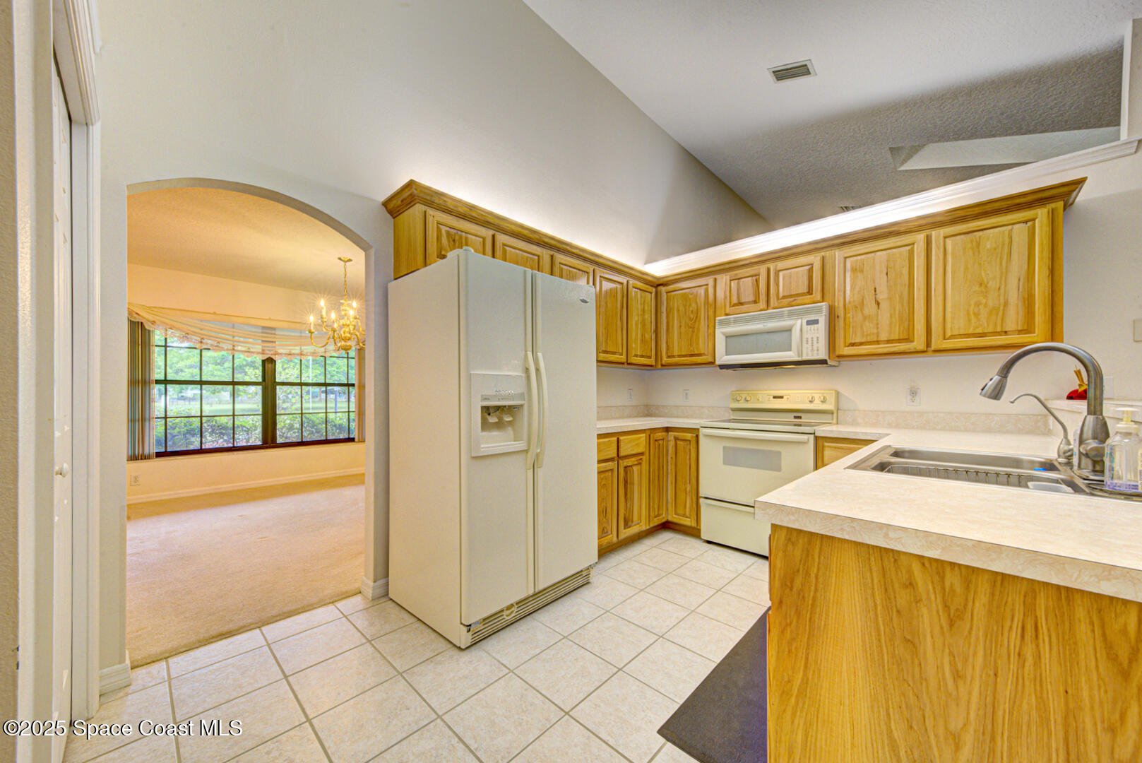 3105 Diamond Road Titusville, FL 32796 - Photo 19 of 81 a kitchen with a refrigerator sink and cabinets