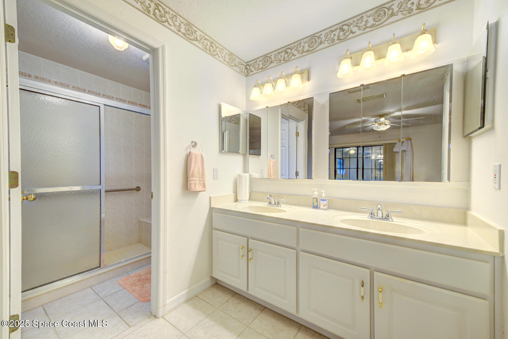 3105 Diamond Road Titusville, FL 32796 - Photo 26 of 81 a spacious bathroom with a shower sink and mirror