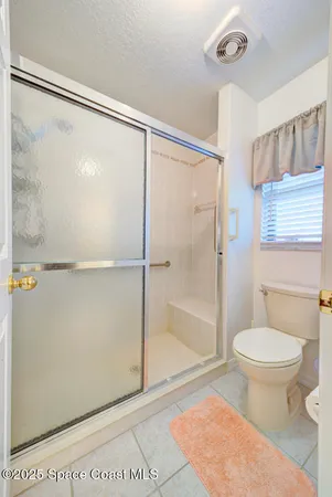 a bathroom with a double vanity sink a mirror and a toilet