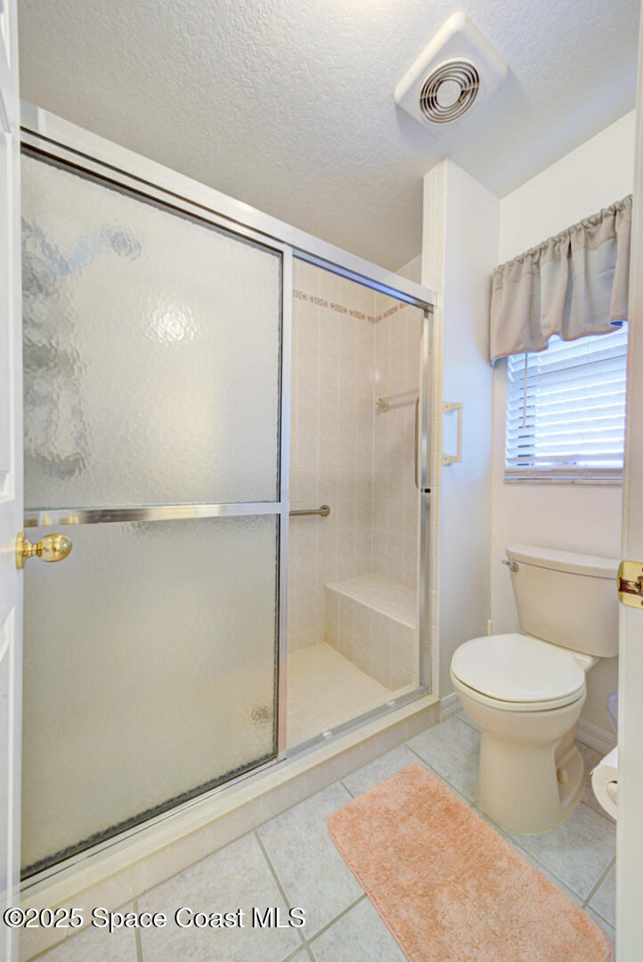 3105 Diamond Road Titusville, FL 32796 - Photo 27 of 81 a bathroom with a shower a toilet and a shower