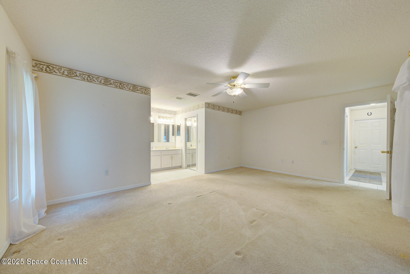 3105 Diamond Road Titusville, FL 32796 - Photo 29 of 81 a view of an empty room with a ceiling fan