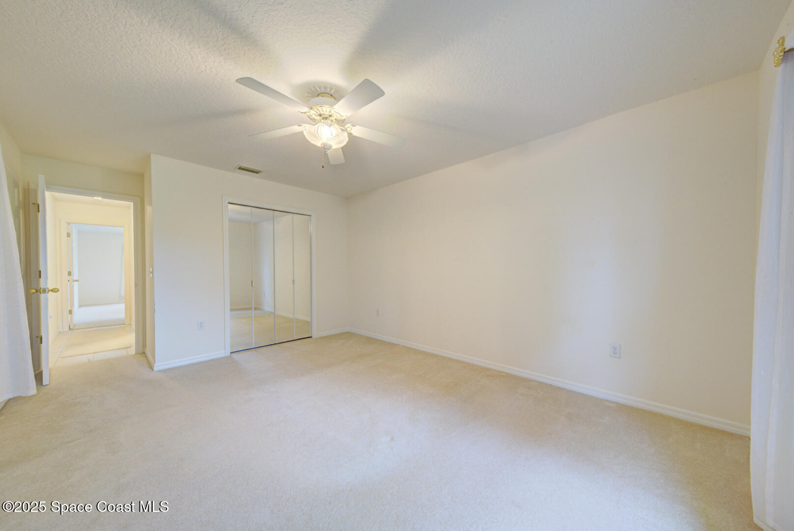 3105 Diamond Road Titusville, FL 32796 - Photo 36 of 81 a view of an empty room and chandelier fan