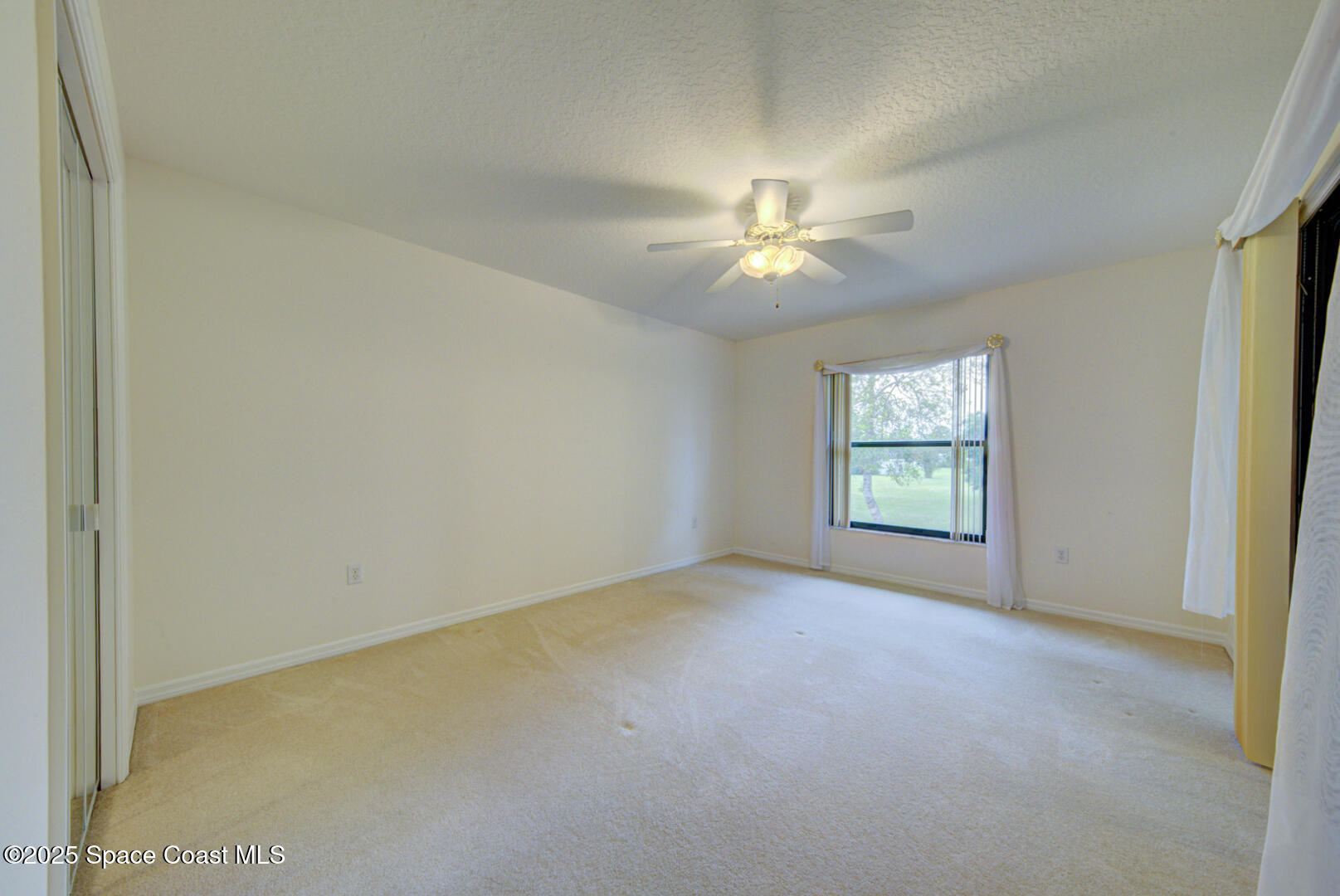 3105 Diamond Road Titusville, FL 32796 - Photo 37 of 81 an empty room with windows and fan