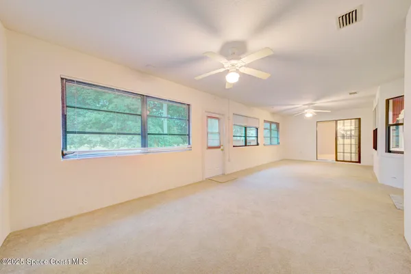 a view of an empty room with windows
