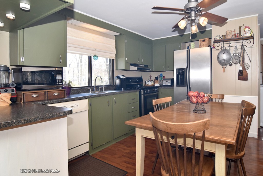 301 Bulgarmarsh Road, Unit F7 Tiverton, RI 02878 - Photo 12 of 30 a kitchen with granite countertop a sink cabinets and stainless steel appliances