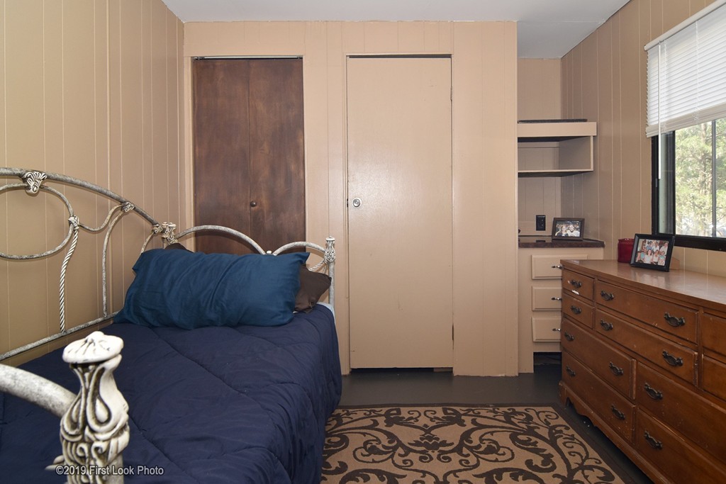 301 Bulgarmarsh Road, Unit F7 Tiverton, RI 02878 - Photo 18 of 30 a bedroom with a bed and cabinets