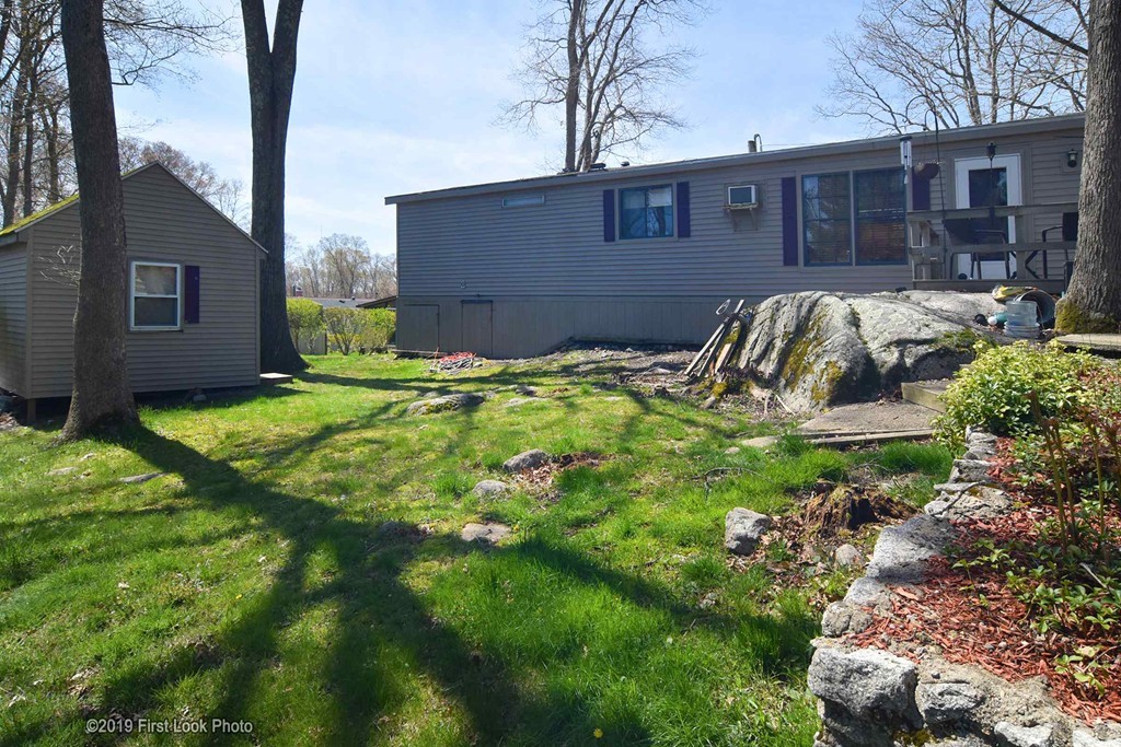 301 Bulgarmarsh Road, Unit F7 Tiverton, RI 02878 - Photo 2 of 30 a front view of a house with garden