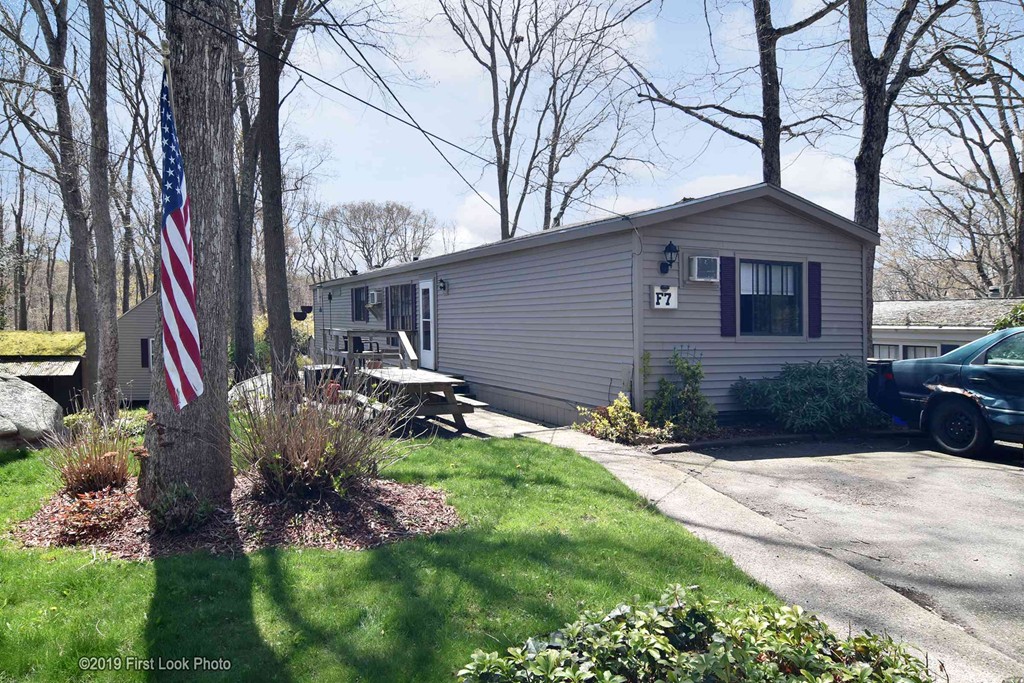 301 Bulgarmarsh Road, Unit F7 Tiverton, RI 02878 - Photo 29 of 30 a backyard of a house with yard and outdoor seating