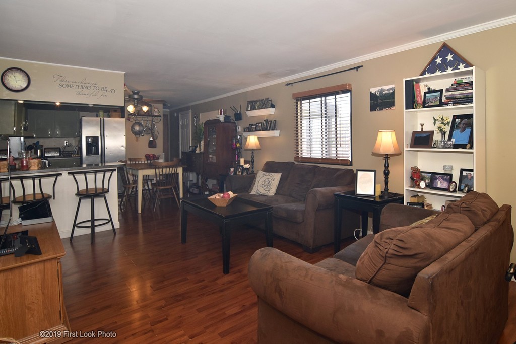 301 Bulgarmarsh Road, Unit F7 Tiverton, RI 02878 - Photo 6 of 30 a living room with furniture and wooden floor