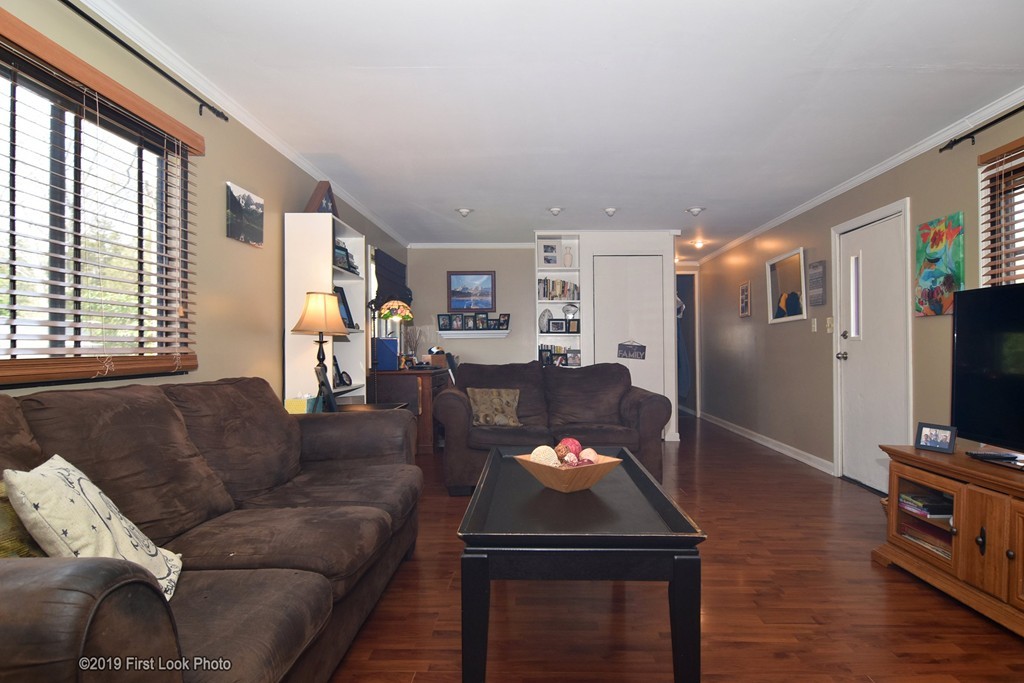 301 Bulgarmarsh Road, Unit F7 Tiverton, RI 02878 - Photo 8 of 30 a living room with furniture and a flat screen tv