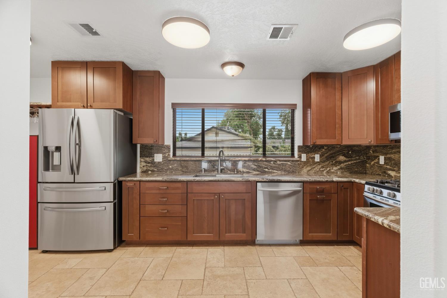 Undisclosed Address Springville, CA 93265 - Photo 17 of 62 a kitchen with stainless steel appliances granite countertop a stove a refrigerator and a sink