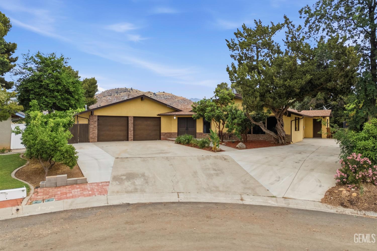 Undisclosed Address Springville, CA 93265 - Photo 2 of 62 a front view of a house with a yard and garage