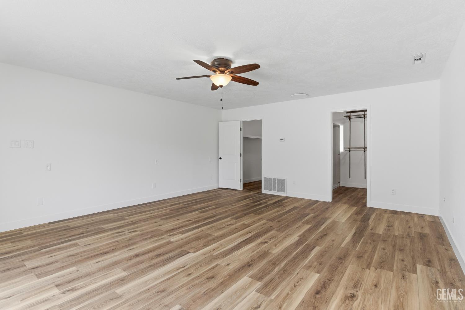 Undisclosed Address Springville, CA 93265 - Photo 25 of 62 a view of empty room with wooden floor and fan