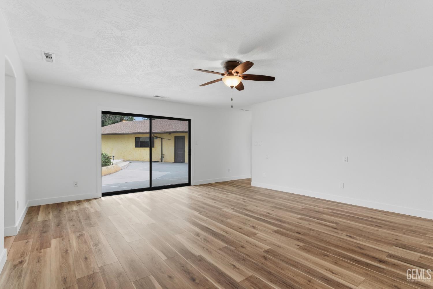 Undisclosed Address Springville, CA 93265 - Photo 26 of 62 a view of an empty room with a window and wooden floor