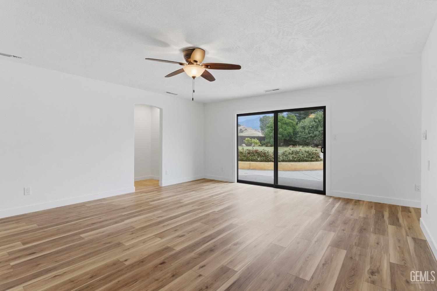 Undisclosed Address Springville, CA 93265 - Photo 27 of 62 a view of an empty room with a window and wooden floor