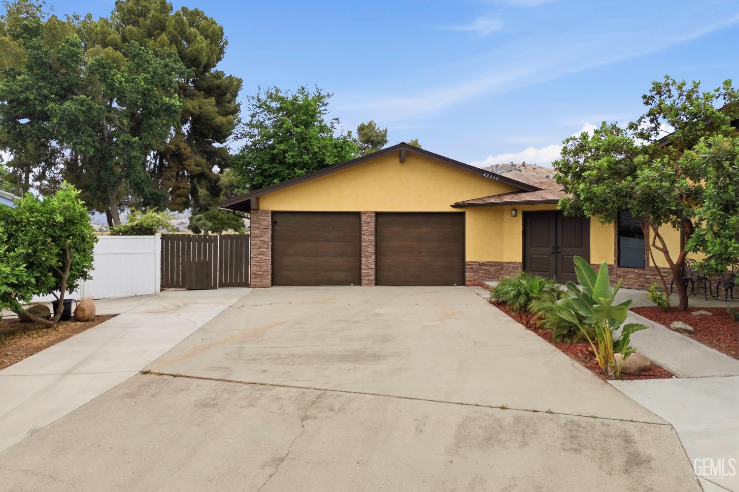 Undisclosed Address Springville, CA 93265 - Photo 3 of 62 a front view of a house with a yard and garage