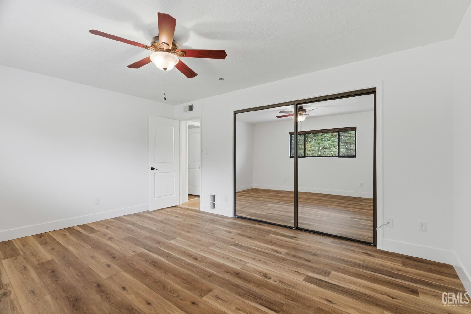 Undisclosed Address Springville, CA 93265 - Photo 40 of 62 a view of a room with wooden floor and a ceiling fan