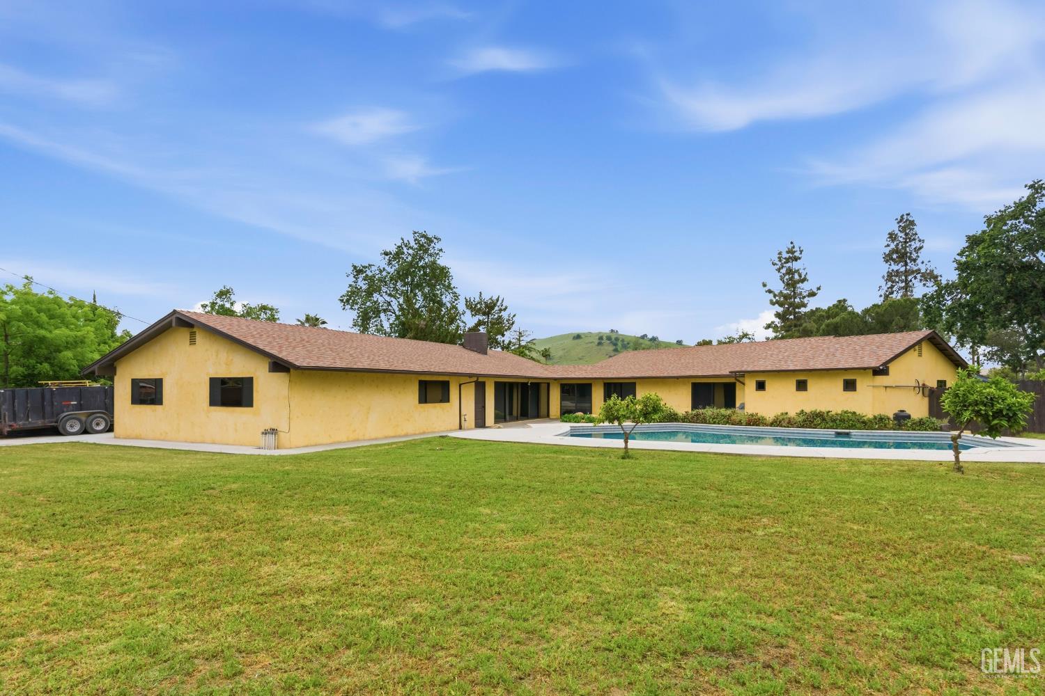 Undisclosed Address Springville, CA 93265 - Photo 50 of 62 a white house with a big yard and large trees