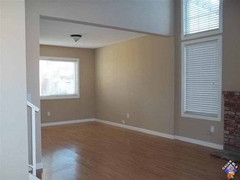 1726 East Ave R12 Palmdale, CA 93550 - Photo 2 of 12 an empty room with wooden floor and windows