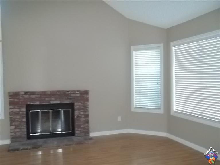 1726 East Ave R12 Palmdale, CA 93550 - Photo 3 of 12 a living room with a fireplace and a window