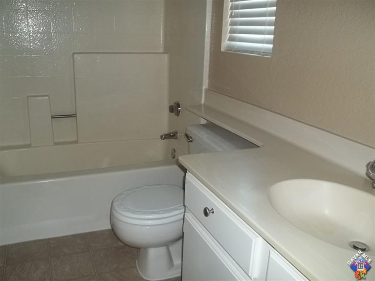 1726 East Ave R12 Palmdale, CA 93550 - Photo 9 of 12 a bathroom with a toilet and a bathtub