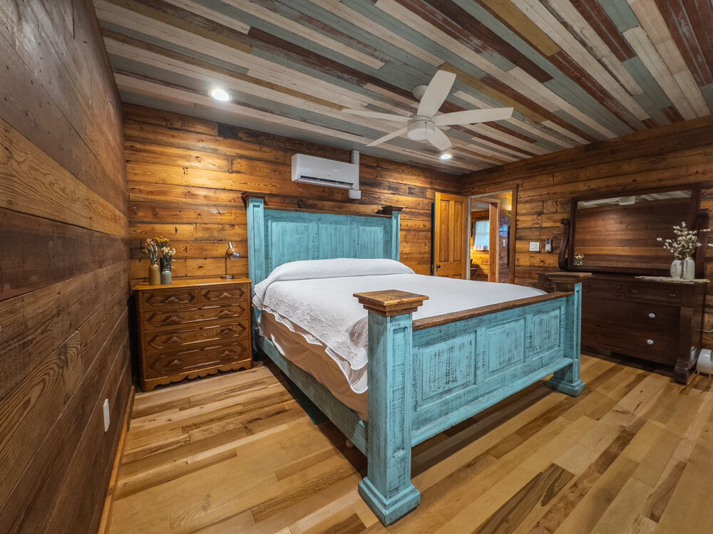 1148 Gunter Street Austin, TX 78721 - Photo 15 of 38 a bedroom with a bed and a walk in closet