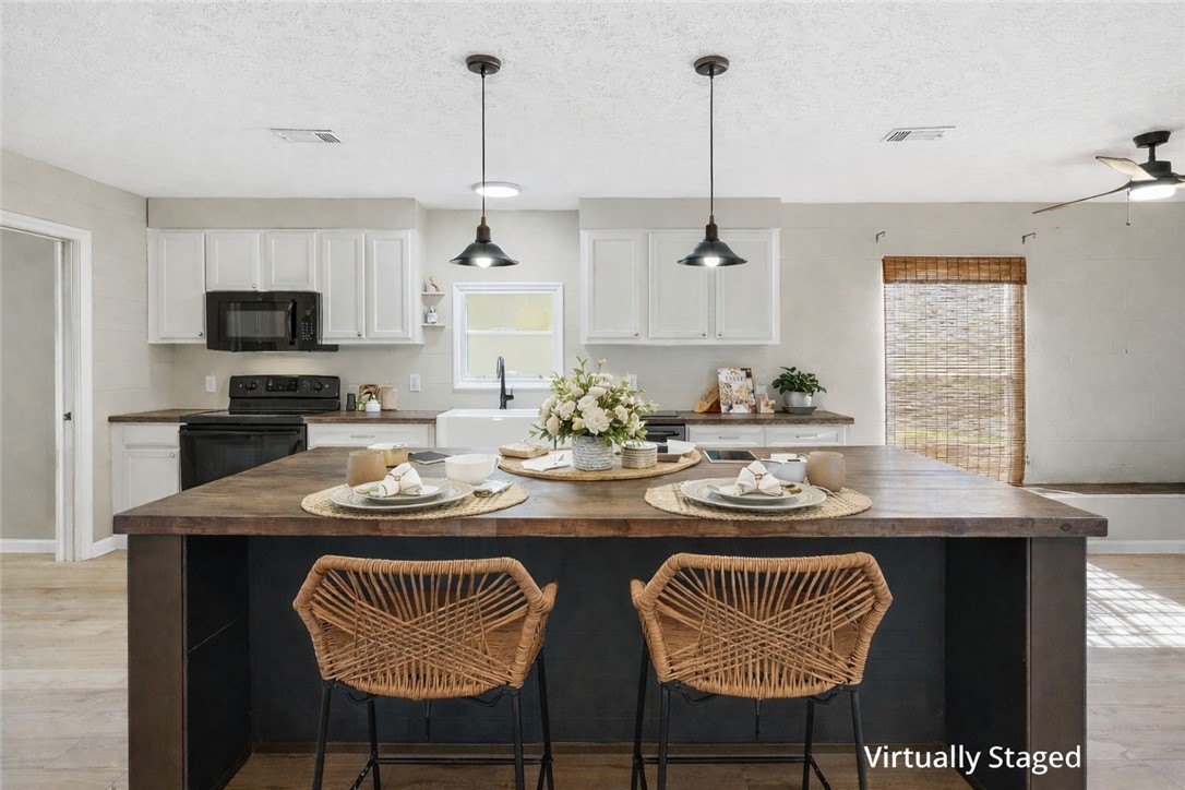 124 County Road 632 Sinton, TX 78387 - Photo 13 of 40 a kitchen with stainless steel appliances granite countertop a dining table and chairs