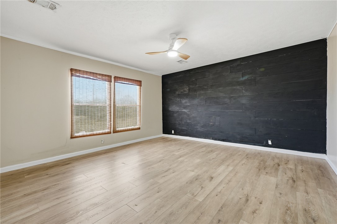 124 County Road 632 Sinton, TX 78387 - Photo 18 of 40 a view of an empty room with wooden floor and a window