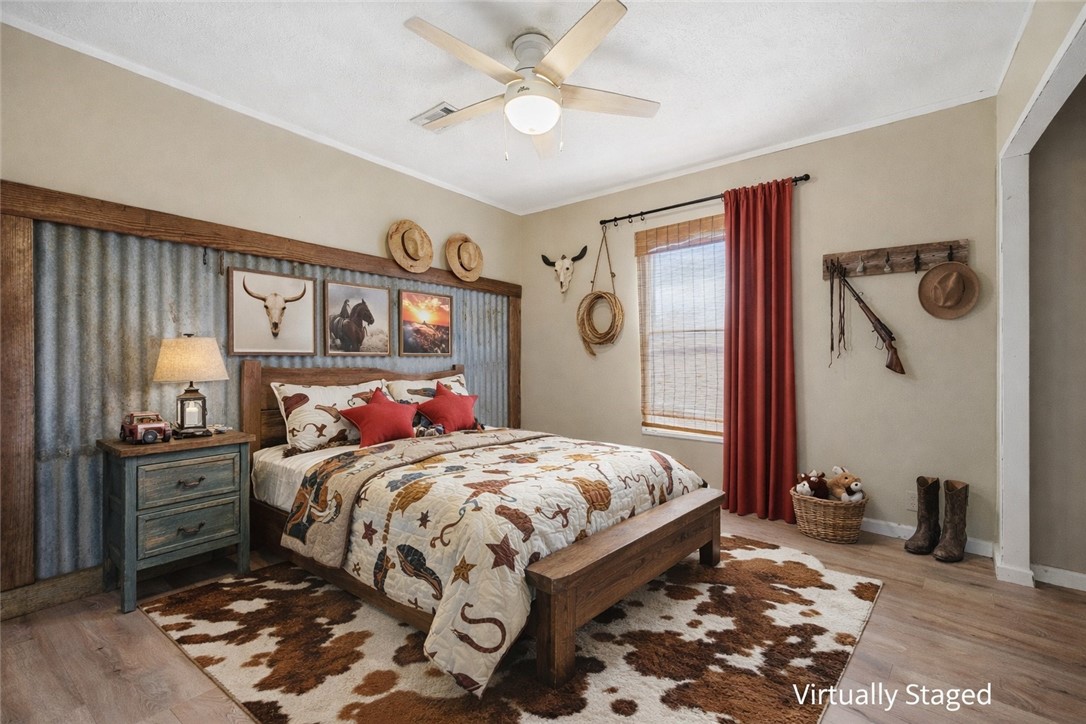 124 County Road 632 Sinton, TX 78387 - Photo 27 of 40 a bedroom with a bed and dresser with mirror