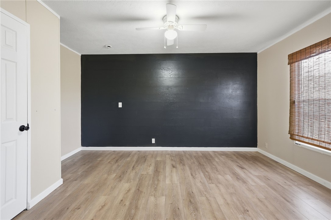 124 County Road 632 Sinton, TX 78387 - Photo 9 of 40 an empty room with wooden floor and windows