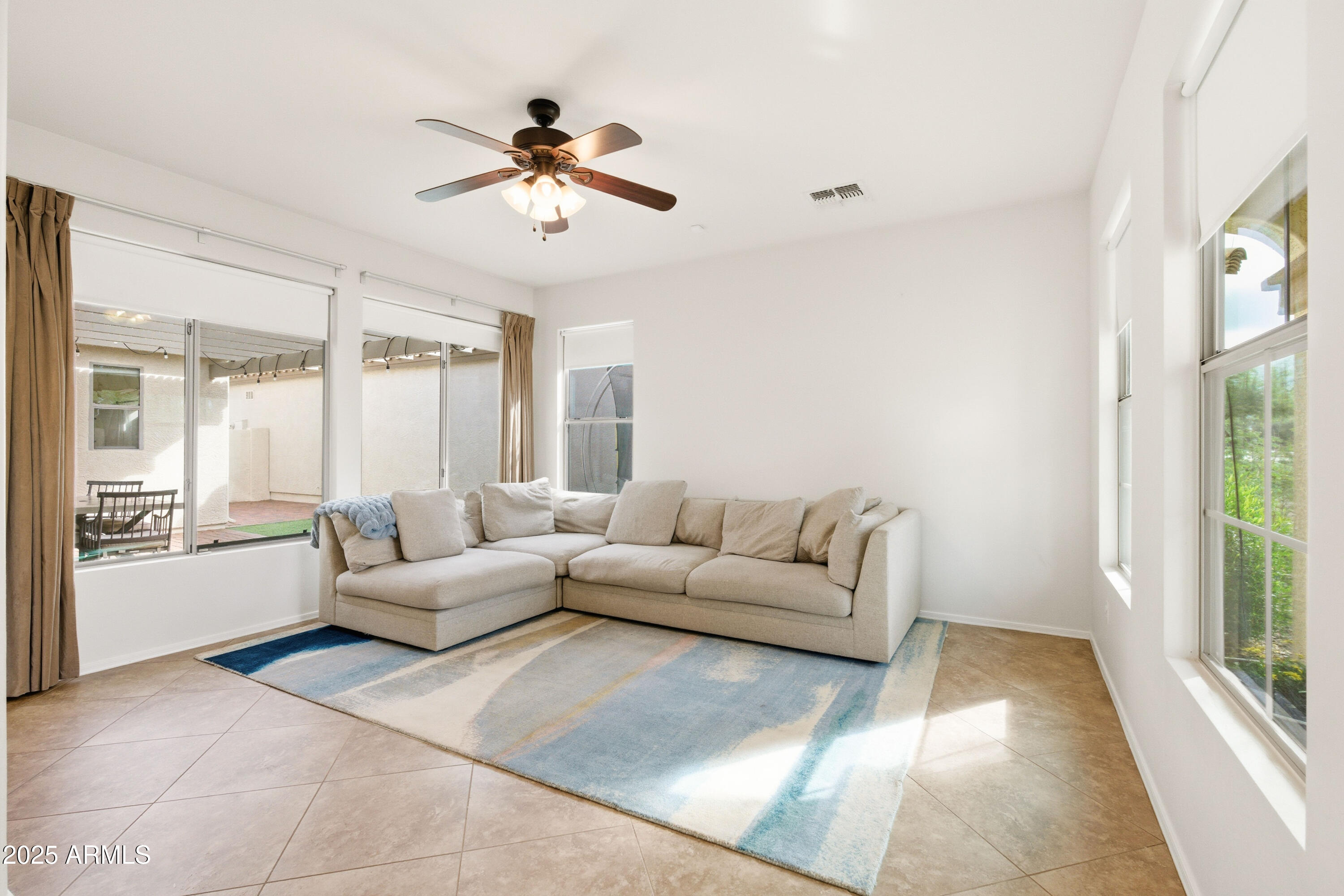 4495 East Woodside Way Gilbert, AZ 85297 - Photo 12 of 80 a living room with furniture and a large window