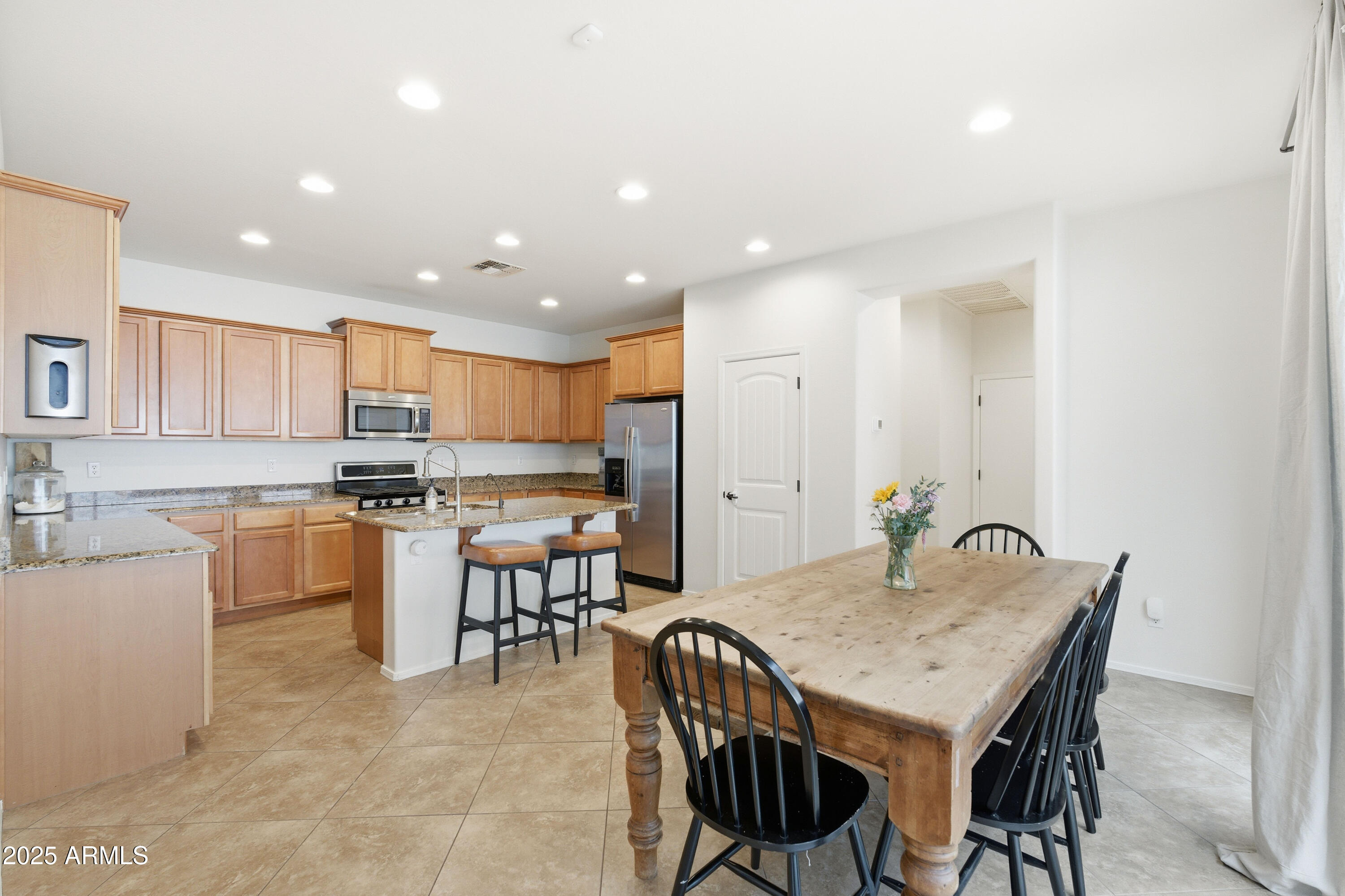 4495 East Woodside Way Gilbert, AZ 85297 - Photo 17 of 80 a kitchen with a table and chairs in it
