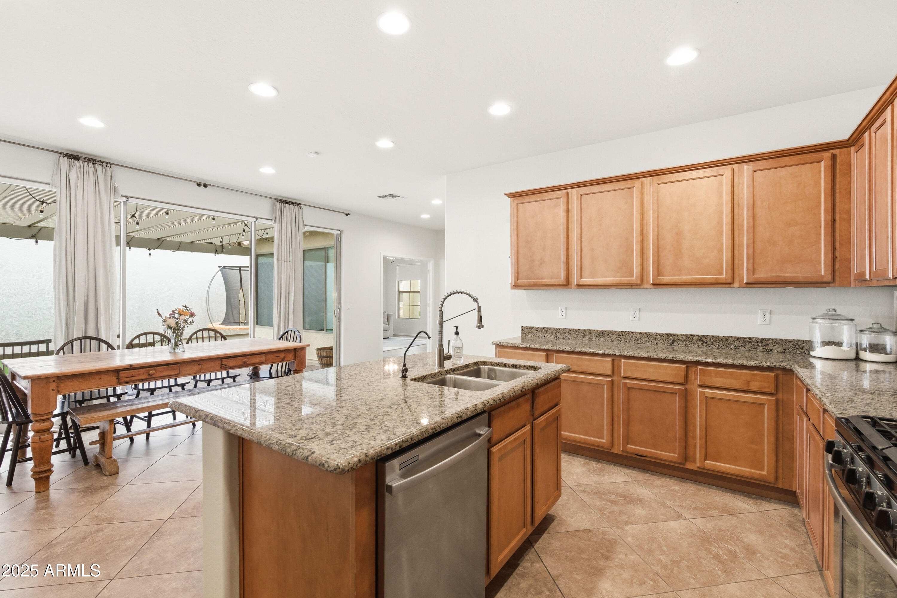 4495 East Woodside Way Gilbert, AZ 85297 - Photo 23 of 80 a kitchen with granite countertop a sink and cabinets