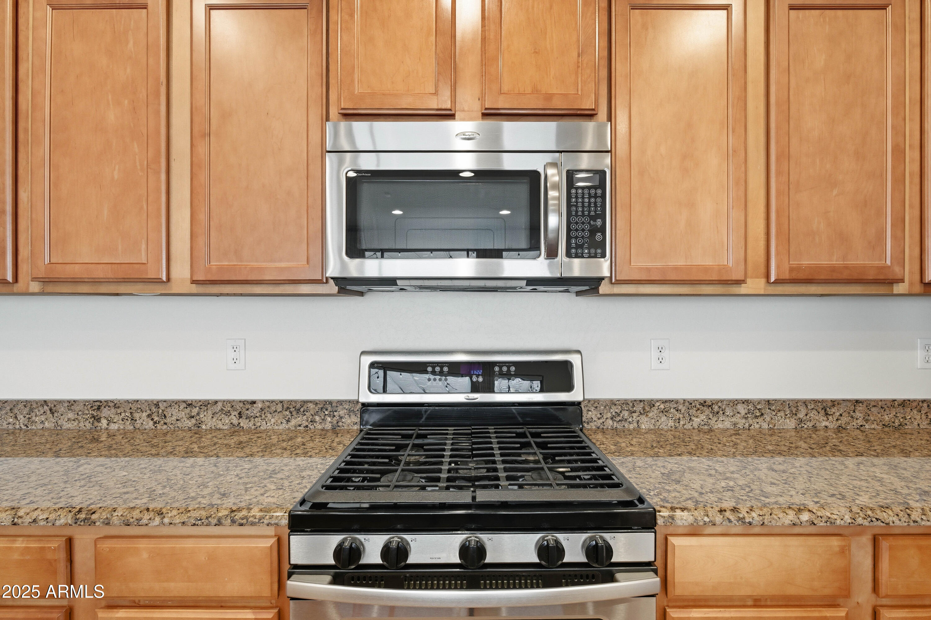 4495 East Woodside Way Gilbert, AZ 85297 - Photo 26 of 80 a kitchen with granite countertop a stove a microwave and cabinets