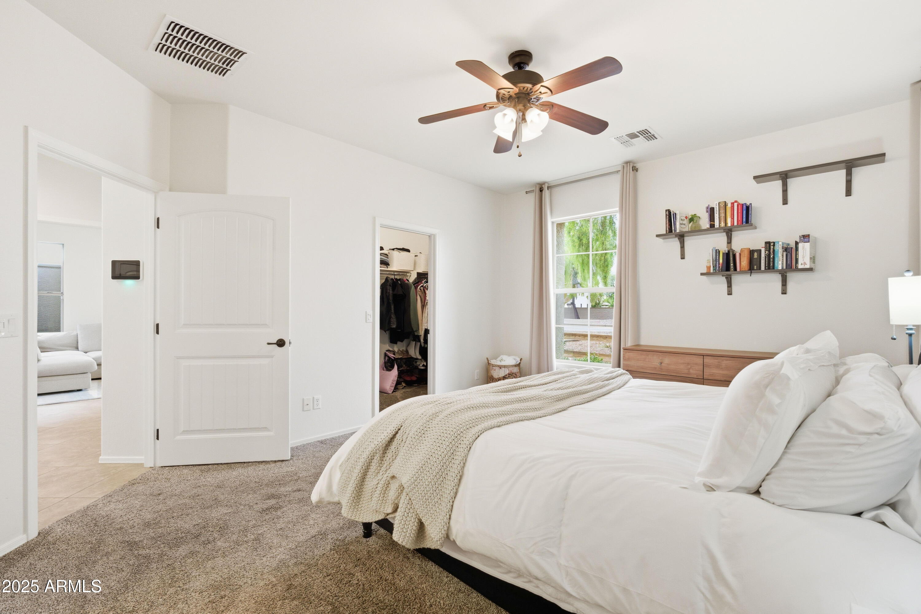 4495 East Woodside Way Gilbert, AZ 85297 - Photo 3 of 80 a bedroom with a large bed a chandelier and closet