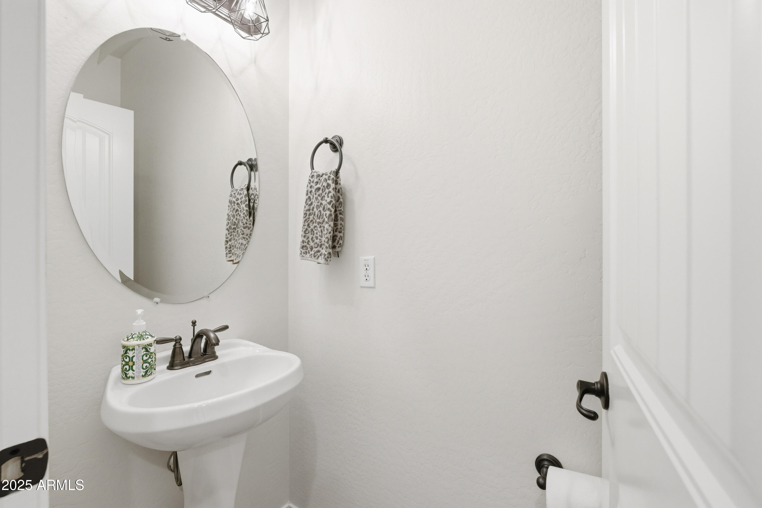 4495 East Woodside Way Gilbert, AZ 85297 - Photo 35 of 80 a bathroom with a sink a mirror and a shower