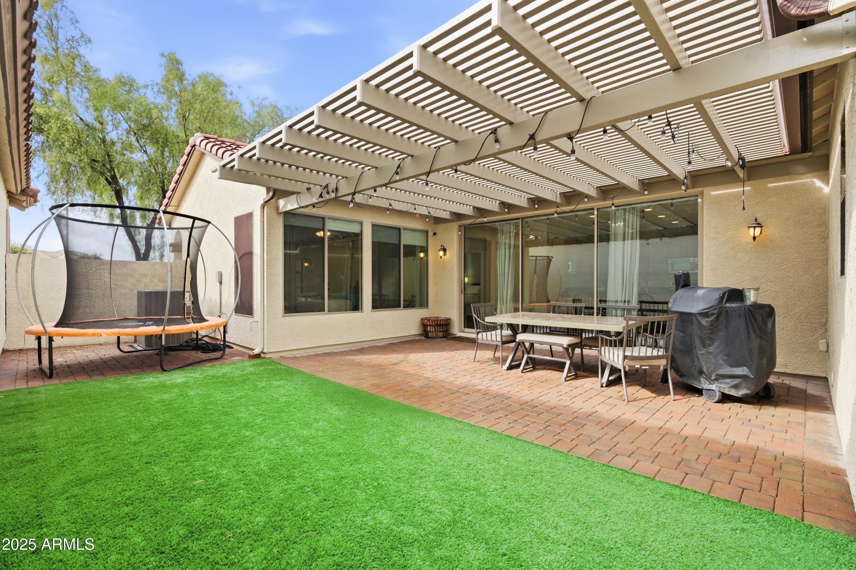 4495 East Woodside Way Gilbert, AZ 85297 - Photo 38 of 80 a view of a patio with table and chairs and potted plants
