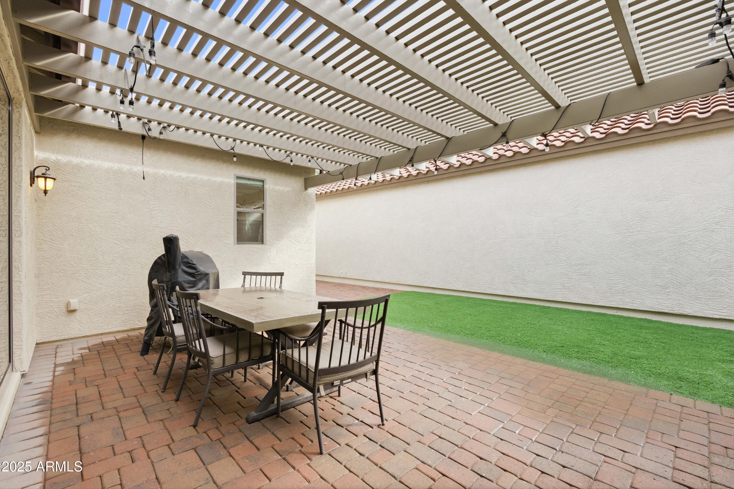 4495 East Woodside Way Gilbert, AZ 85297 - Photo 4 of 80 a view of a patio with table and chairs with wooden floor