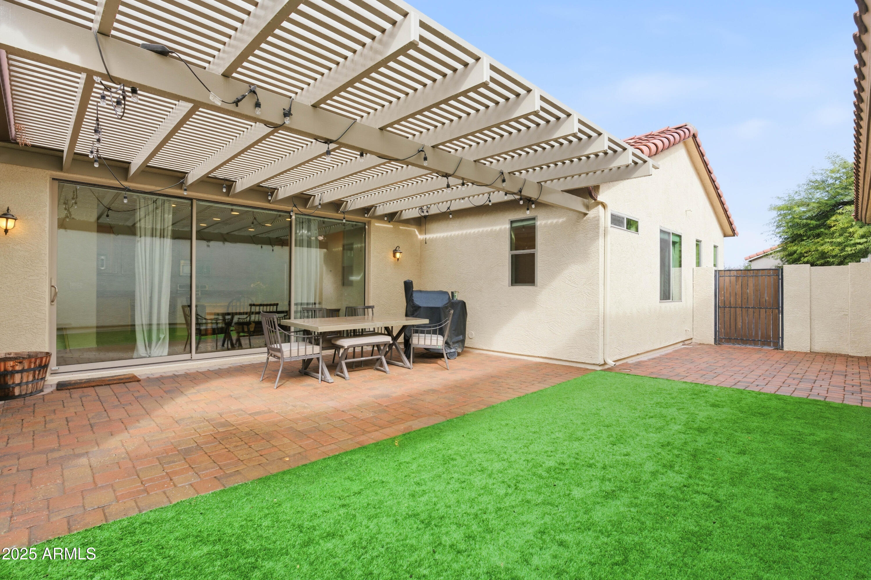 4495 East Woodside Way Gilbert, AZ 85297 - Photo 5 of 80 a view of a backyard with table and chairs