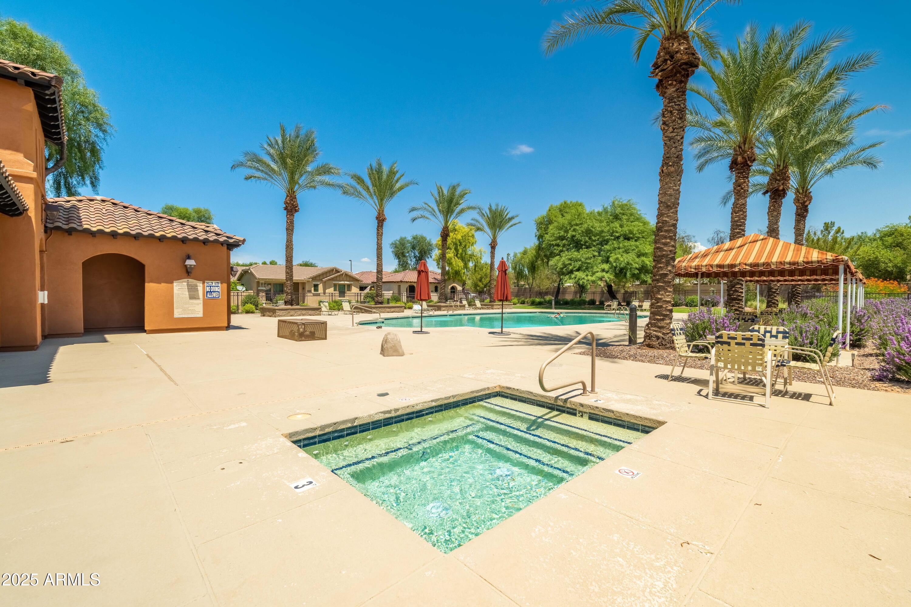 4495 East Woodside Way Gilbert, AZ 85297 - Photo 51 of 80 a view of a swimming pool with tables and chairs