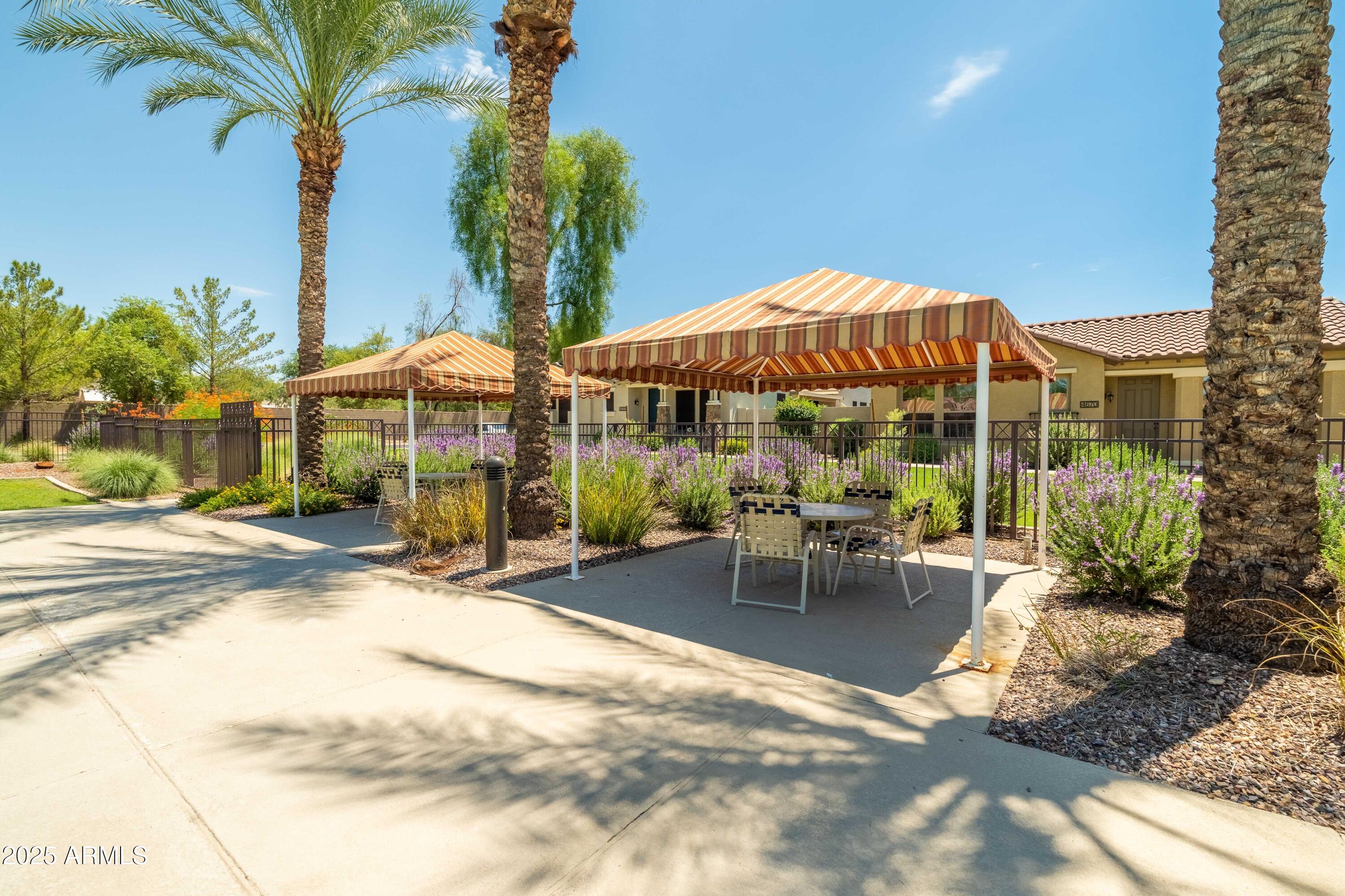 4495 East Woodside Way Gilbert, AZ 85297 - Photo 53 of 80 a view of a patio with a table and chairs under an umbrella