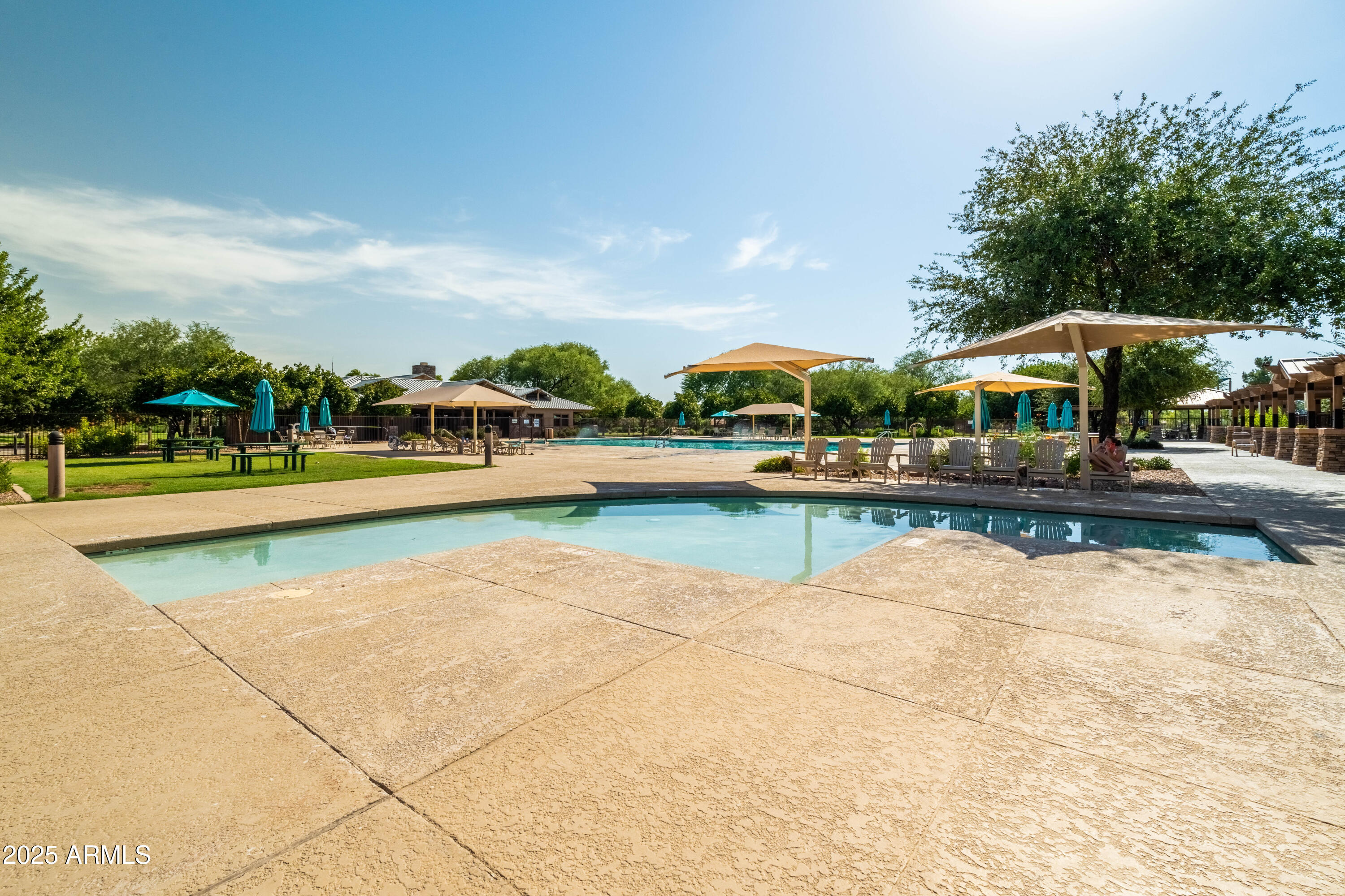 4495 East Woodside Way Gilbert, AZ 85297 - Photo 72 of 80 a view of swimming pool with outdoor seating and trees in the background