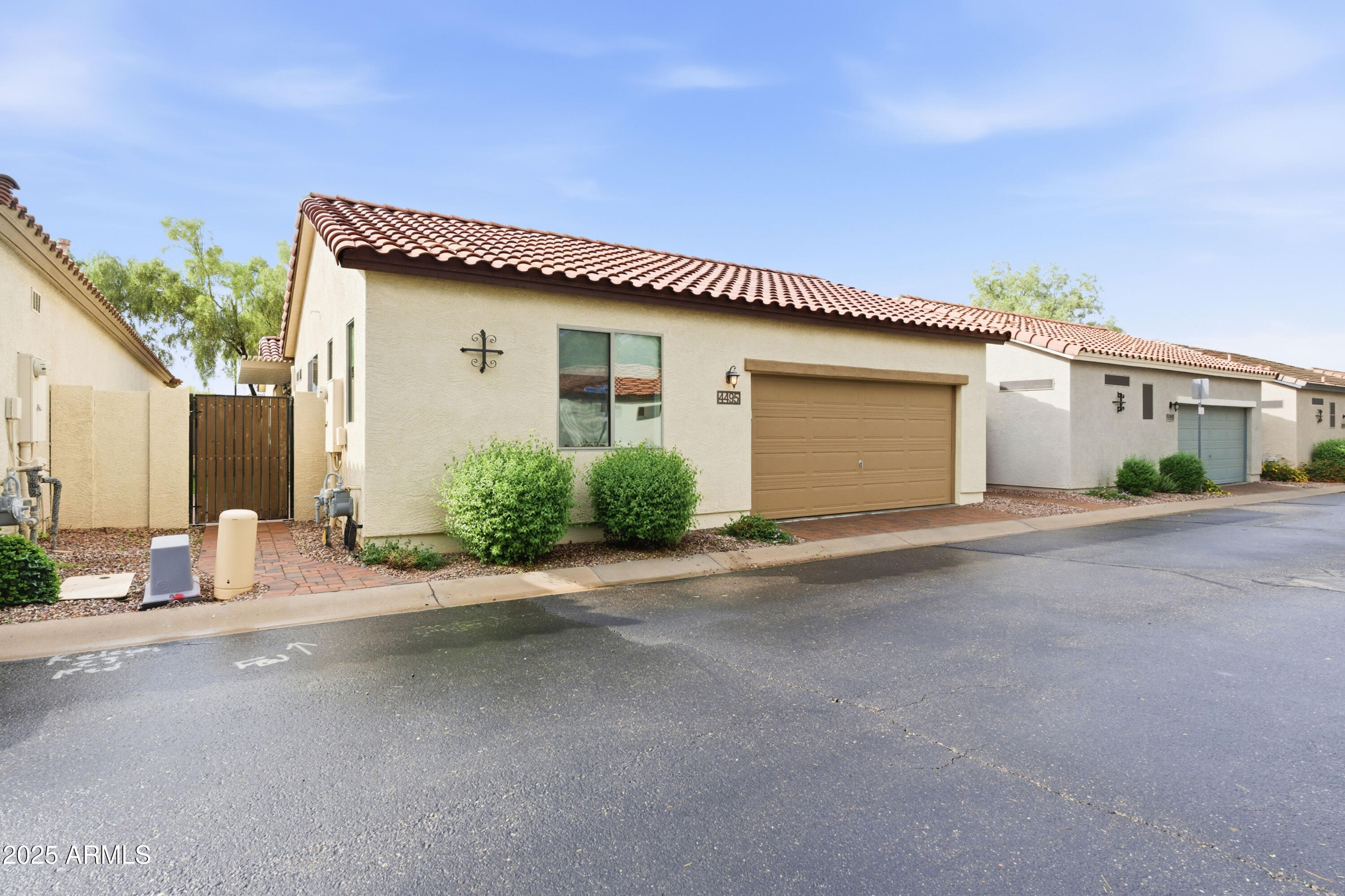 4495 East Woodside Way Gilbert, AZ 85297 - Photo 9 of 80 a front view of a house with a yard and garage