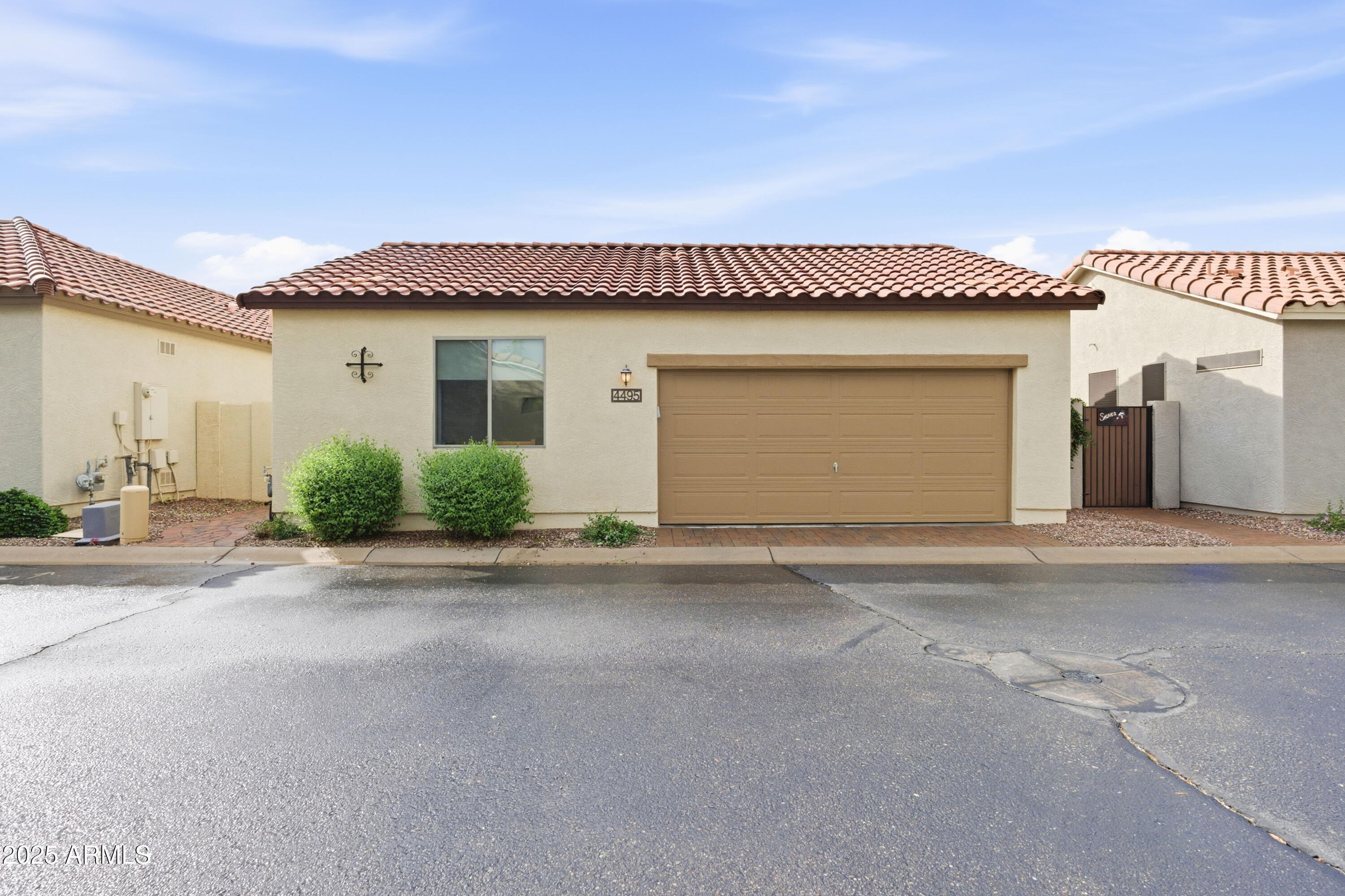 4495 East Woodside Way Gilbert, AZ 85297 - Photo 10 of 80 a front view of a house with a yard and garage